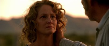 Movie still from “The Three Burials of Melquiades Estrada” (2005), directed by Tommy Lee Jones – A person touching the ear of another person; Close Up shot, Low angle