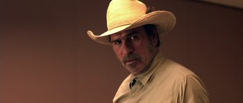 Movie still from “The Three Burials of Melquiades Estrada” (2005), directed by Tommy Lee Jones – A person wearing a straw hat; Close Up shot, Over the shoulder angle