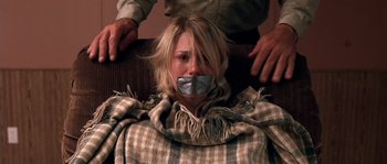 Movie still from “The Three Burials of Melquiades Estrada” (2005), directed by Tommy Lee Jones – A woman with duct tape over her mouth; Close Up shot, Low angle