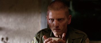 Movie still from “The Three Burials of Melquiades Estrada” (2005), directed by Tommy Lee Jones – A person holding a cell phone; Close Up shot, Over the shoulder angle