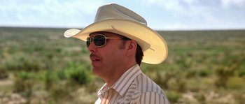 Movie still from “The Three Burials of Melquiades Estrada” (2005), directed by Tommy Lee Jones – A man wearing a cowboy hat and sun glasses; Close Up shot, Low angle