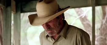 Movie still from “The Three Burials of Melquiades Estrada” (2005), directed by Tommy Lee Jones – An older man wearing a straw cowboy hat; Close Up shot, Low angle
