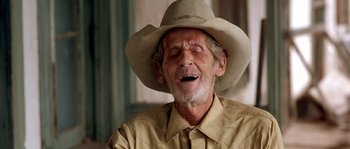 Movie still from “The Three Burials of Melquiades Estrada” (2005), directed by Tommy Lee Jones – An older man wearing a cowboy hat and a yellow shirt; Close Up shot, Low angle