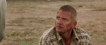 Movie still from “The Three Burials of Melquiades Estrada” (2005), directed by Tommy Lee Jones – A person wearing a camouflage shirt; Close Up shot, Over the shoulder angle