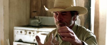 Movie still from “The Three Burials of Melquiades Estrada” (2005), directed by Tommy Lee Jones – An old man wearing a straw cowboy hat; Close Up shot, Over the shoulder angle