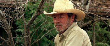 Movie still from “The Three Burials of Melquiades Estrada” (2005), directed by Tommy Lee Jones – An older man wearing a straw cowboy hat; Close Up shot, Over the shoulder angle