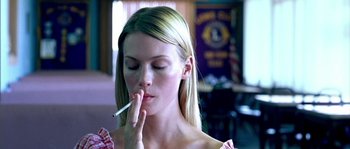 Movie still from “The Three Burials of Melquiades Estrada” (2005), directed by Tommy Lee Jones – A beautiful young lady holding a cigarette in her mouth; Close Up shot, High angle