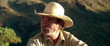 Movie still from “The Three Burials of Melquiades Estrada” (2005), directed by Tommy Lee Jones – A person wearing a straw hat; Close Up shot, Over the shoulder angle