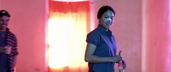 Movie still from “The Three Burials of Melquiades Estrada” (2005), directed by Tommy Lee Jones – A woman holding a toothbrush in her mouth; Medium shot, Low angle