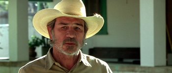 Movie still from “The Three Burials of Melquiades Estrada” (2005), directed by Tommy Lee Jones – An older man wearing a straw cowboy hat; Close Up shot, Over the shoulder angle