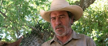 Movie still from “The Three Burials of Melquiades Estrada” (2005), directed by Tommy Lee Jones – An older man wearing a straw cowboy hat; Close Up shot, Low angle