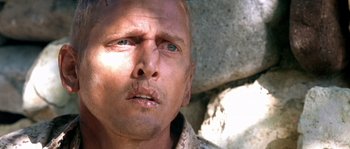 Movie still from “The Three Burials of Melquiades Estrada” (2005), directed by Tommy Lee Jones – A man's face in front of a stone wall; Close Up shot, Low angle