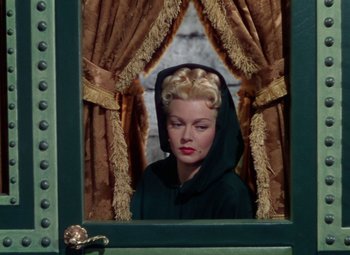 Movie still from “The Three Musketeers” (1948), directed by George Sidney – A woman with blonde hair wearing a black hooded jacket; Medium shot, Low angle