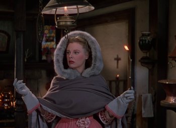 Movie still from “The Three Musketeers” (1948), directed by George Sidney – A woman in a fur trimmed cape holding a candle; Medium shot, Low angle