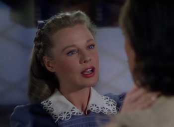 Movie still from “The Three Musketeers” (1948), directed by George Sidney – A young woman with blonde hair wearing a blue dress; Close Up shot, Over the shoulder angle