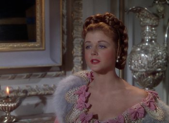 Movie still from “The Three Musketeers” (1948), directed by George Sidney – A woman in a pink and white dress; Close Up shot, Over the shoulder angle