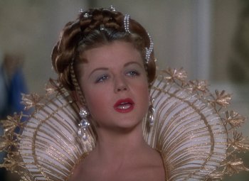 Movie still from “The Three Musketeers” (1948), directed by George Sidney – A woman in a dress and a crown; Close Up shot, Over the shoulder angle