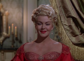 Movie still from “The Three Musketeers” (1948), directed by George Sidney – A woman in a red dress with a long blonde wig; Close Up shot, Low angle