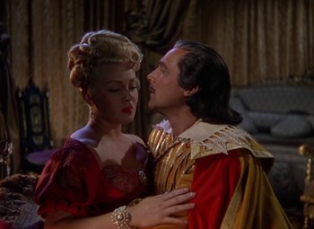 Movie still from “The Three Musketeers” (1948), directed by George Sidney – A man and a woman in medieval garb embracing each other; Medium shot, Over the shoulder angle