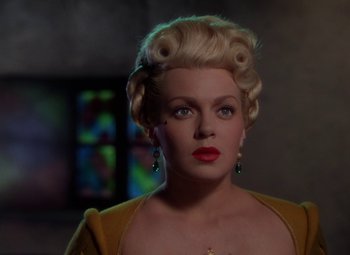 Movie still from “The Three Musketeers” (1948), directed by George Sidney – A woman with blonde hair wearing a yellow sweater; Close Up shot, Over the shoulder angle