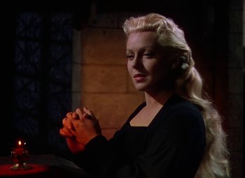 Movie still from “The Three Musketeers” (1948), directed by George Sidney – A woman with long blonde hair is holding her hands in prayer; Close Up shot, Over the shoulder angle