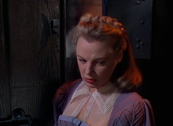 Movie still from “The Three Musketeers” (1948), directed by George Sidney – A woman in a purple dress looking down at the ground; Close Up shot, Low angle