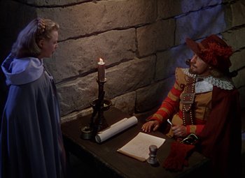 Movie still from “The Three Musketeers” (1948), directed by George Sidney – A man and a woman in medieval garb writing on a paper; Medium shot, High angle