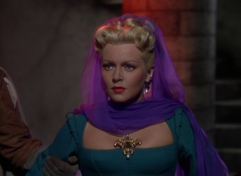 Movie still from “The Three Musketeers” (1948), directed by George Sidney – A woman in a blue dress with a purple veil; Close Up shot, Over the shoulder angle