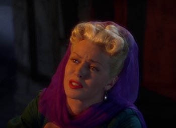 Movie still from “The Three Musketeers” (1948), directed by George Sidney – A woman with a purple scarf on her head; Close Up shot, High angle