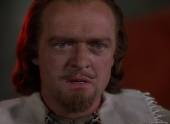 Movie still from “The Three Musketeers” (1948), directed by George Sidney – A person with long hair and a beard; Close Up shot, Over the shoulder angle