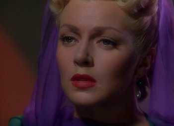 Movie still from “The Three Musketeers” (1948), directed by George Sidney – A person wearing a purple dress; Close Up shot, Low angle