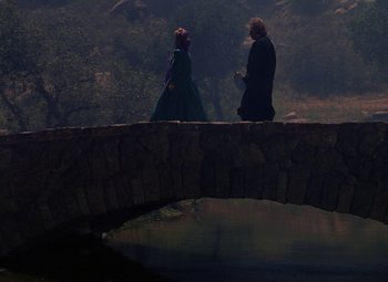 Movie still from “The Three Musketeers” (1948), directed by George Sidney – A man and a woman walking across a bridge; Wide shot, Over the shoulder angle
