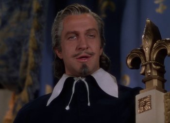 Movie still from “The Three Musketeers” (1948), directed by George Sidney – A person wearing a suit and tie; Close Up shot, Low angle