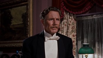 Movie still from “The Time Machine” (1960), directed by George Pal – An older man wearing a tuxedo and a bow tie; Close Up shot, Low angle
