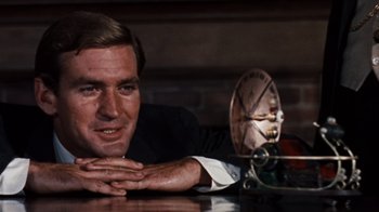 Movie still from “The Time Machine” (1960), directed by George Pal – A person sitting at a table; Close Up shot, Low angle