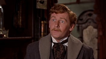 Movie still from “The Time Machine” (1960), directed by George Pal – A person wearing a suit and tie; Close Up shot, Over the shoulder angle