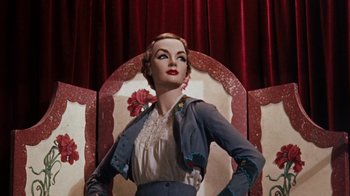 Movie still from “The Time Machine” (1960), directed by George Pal – A wax statue of a woman in a gray jacket; Medium shot, Low angle