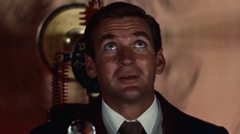 Movie still from “The Time Machine” (1960), directed by George Pal – A person wearing a suit and tie; Close Up shot, Low angle