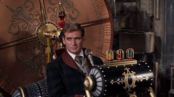Movie still from “The Time Machine” (1960), directed by George Pal – A man sitting in front of a clock; Medium shot, Low angle