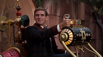 Movie still from “The Time Machine” (1960), directed by George Pal – A man sitting in front of an old fashioned car; Medium shot, Low angle
