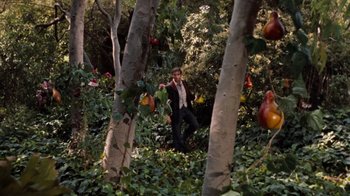 Movie still from “The Time Machine” (1960), directed by George Pal – A man in a suit and tie standing in the woods; Wide shot, High angle