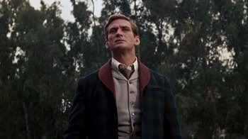 Movie still from “The Time Machine” (1960), directed by George Pal – A man standing in the forest; Medium shot, Low angle