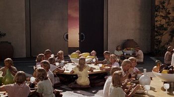 Movie still from “The Time Machine” (1960), directed by George Pal – A group of people sitting around a round table; Extreme Wide shot, High angle