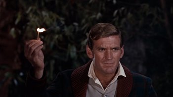 Movie still from “The Time Machine” (1960), directed by George Pal – A person holding a lit candle; Close Up shot, Low angle