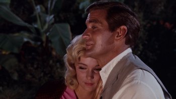 Movie still from “The Time Machine” (1960), directed by George Pal – A man and a woman sitting next to each other; Close Up shot, Low angle