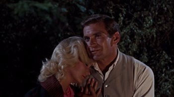 Movie still from “The Time Machine” (1960), directed by George Pal – A man and a woman standing next to each other; Close Up shot, Low angle