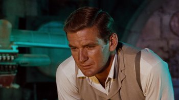 Movie still from “The Time Machine” (1960), directed by George Pal – A person wearing a suit and tie; Close Up shot, Over the shoulder angle