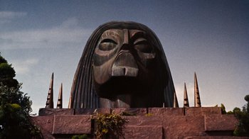 Movie still from “The Time Machine” (1960), directed by George Pal – A statue of a woman's face is shown; Extreme Wide shot, Low angle