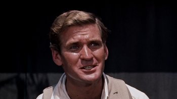 Movie still from “The Time Machine” (1960), directed by George Pal – A person wearing a suit and tie; Close Up shot, Low angle