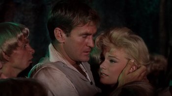 Movie still from “The Time Machine” (1960), directed by George Pal – A man and a woman standing next to each other; Close Up shot, High angle